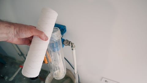 Plumber change water filter. Replacement aqua filter. Technician maintenancing system of water filtration.