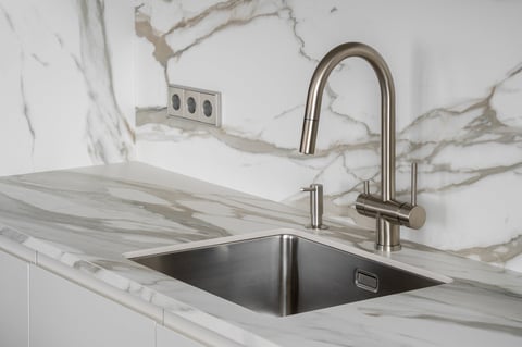 Premium modern kitchen with stainless steel sink, marble countertop and minimalist tap